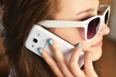 person sunglasses woman smartphone